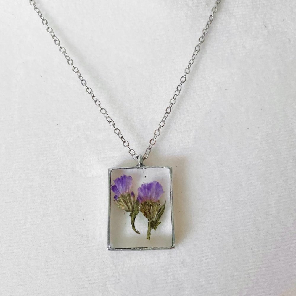 Purple floral botanical flower resin necklace in dark silver bezel